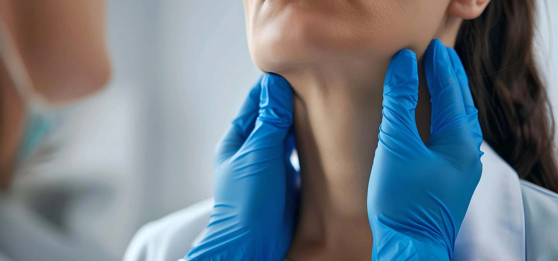 Doctor examining a woman’s thyroid gland.